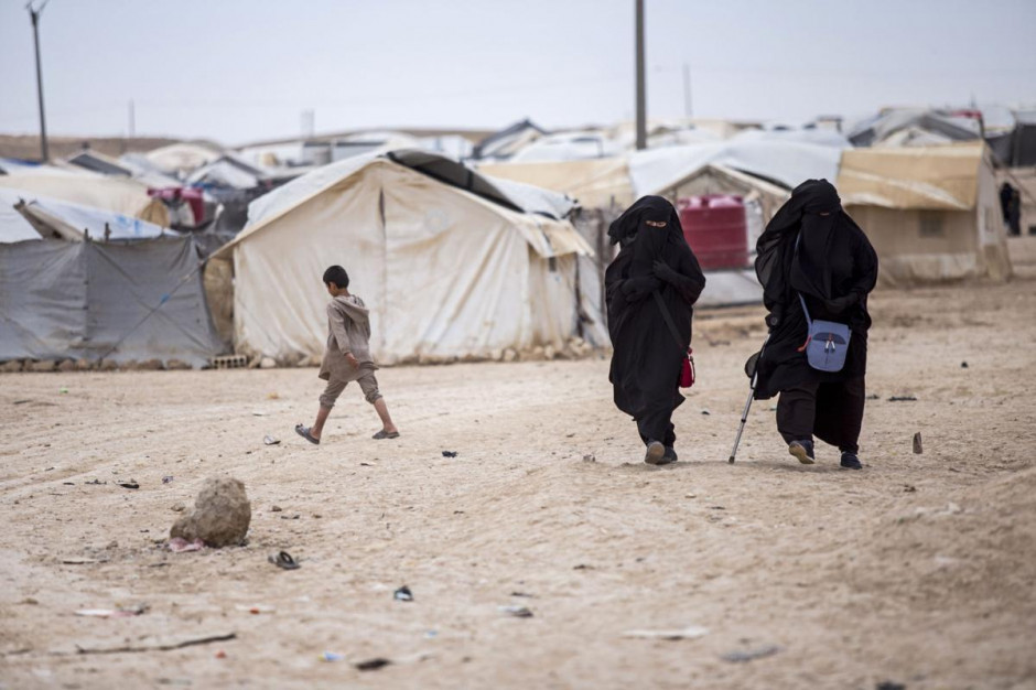 Women walk in the al-Hol camp, which houses some 60,000 refugees, including families and supporters of the Islamic State group, in Hasakeh province in Syria in May.
